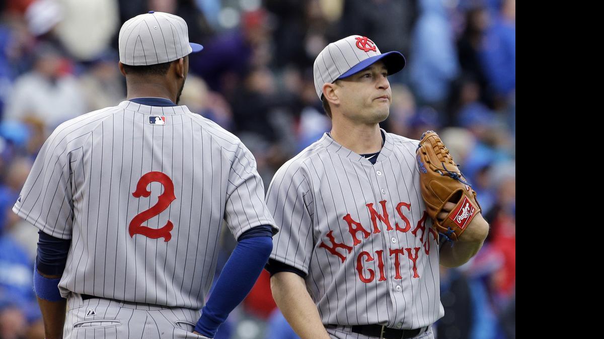 
Kansas City Royals relief pitcher Jason Frasor, right, reacts as he listens to shortstop Alcides Escobar during the 11th inning of a baseball game against the Chicago Cubs on Sunday, May 31, 2015, in Chicago. The Cubs won 2-1. 
