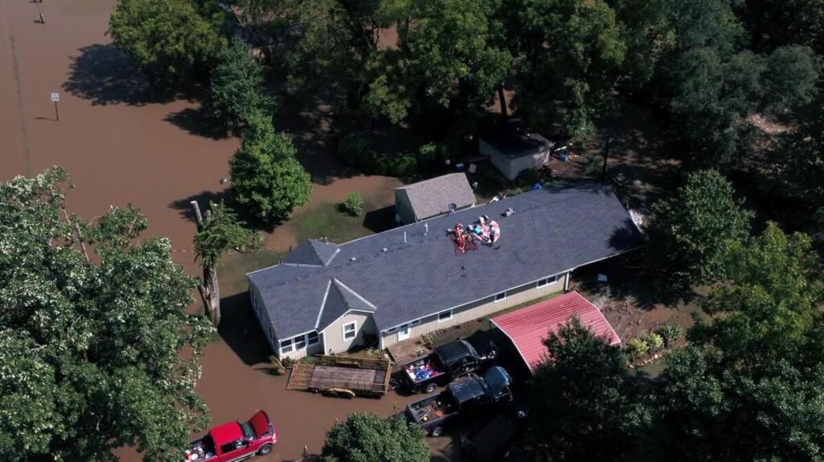 A couple and their five children were stranded on the roof of their home near 155th Street and Kenneth Road for many hours Tuesday. Overland Park Fire Department officials were staged at 151st Street just west of Kenneth Road waiting for floodwaters to recede.
