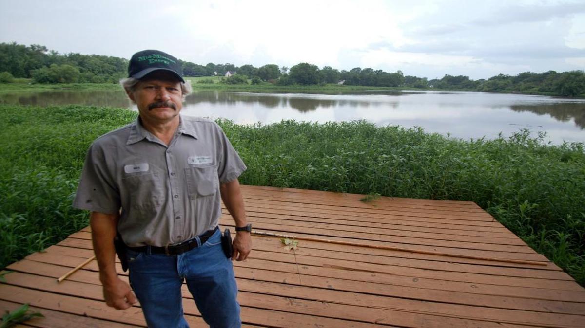 Wesley Steffens’ floating dock now sits on dry land as the water in Blackburn Pond has receded. Last year, a small dam that captured water for the tiny lake busted out amid heavy rains. Residents and local officials want Kansas City Southern, which own the property, to make repairs. The railroad said it has no plans to do so.