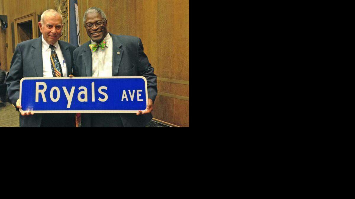
City councilman Dick Davis (left) and Mayor Sly James pose with a “Royals Ave” sign. 
