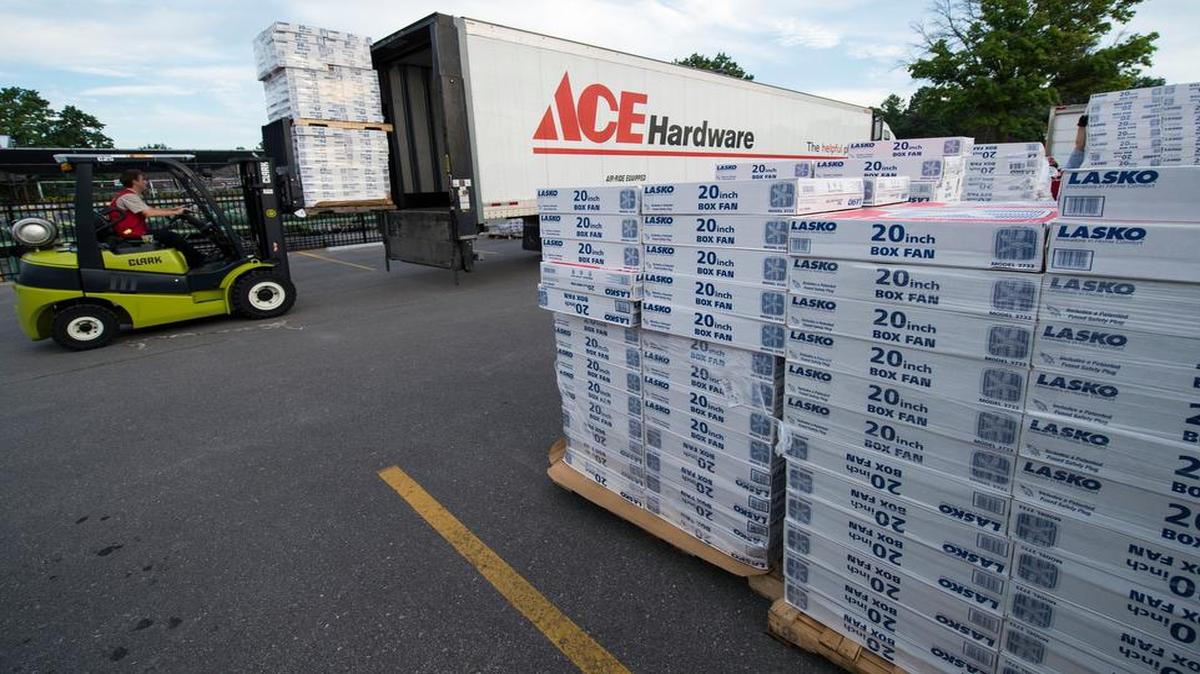
Mitch Randolph (left) operated a forklift while moving pallets on Monday in Prairie Village as the Salvation Army picked up a new supply of more than 1,000 box fans from Westlake Ace Hardware to distribute to those in need.
