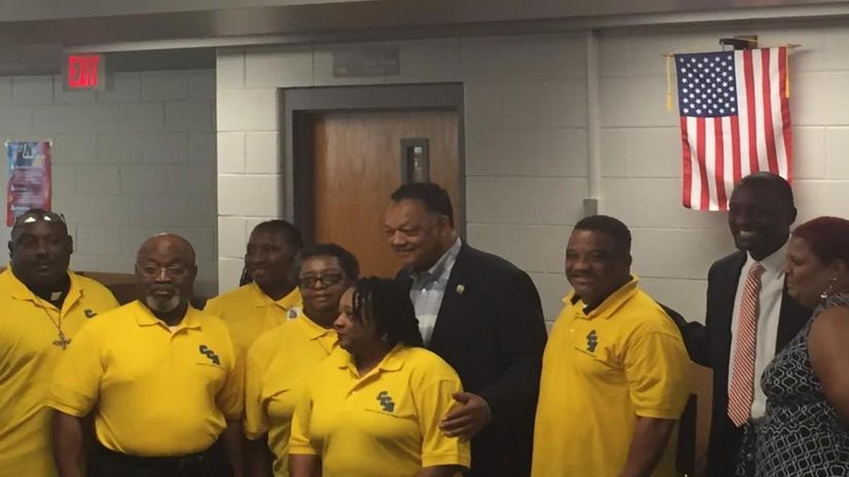 The Rev. Jesse Jackson Sr. poses with Central Academy of Excellence staff before speaking with students about the importance of voting Tuesday.