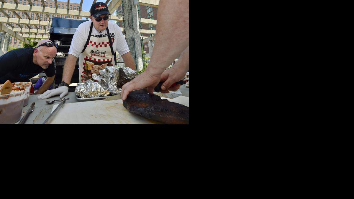 
More than 1,000 chefs are gathering in Kansas City this weekend for the American Chef Federation National Convention, and some decided to learn how to do barbecue Kansas City style. Chefs Greg Sharpe (from left) and Jason Drysdale watched David Spychalski slice beef brisket Friday at Barney Allis Plaza for the Kansas City Barbecue Society barbecue competition. 
