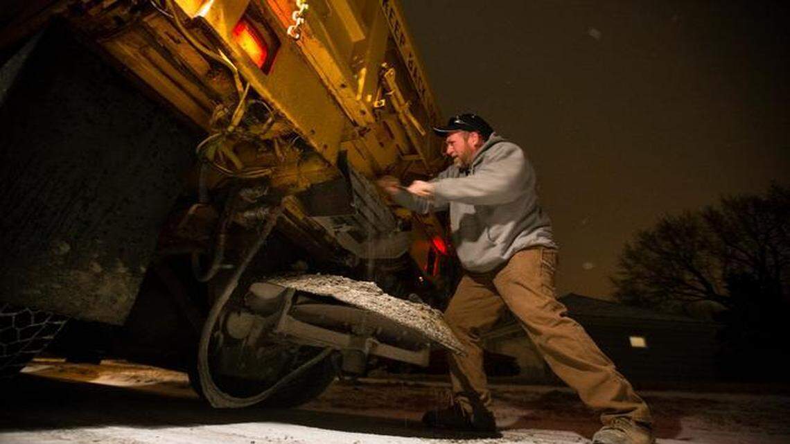 
Missouri and Kansas highways late Sunday were mostly covered with light snow, but did not pose any reported problems for road crews that were working through the night. Roger Overcast of the Overland Public Works Department worked to fix his plow that had broken down Sunday night.
