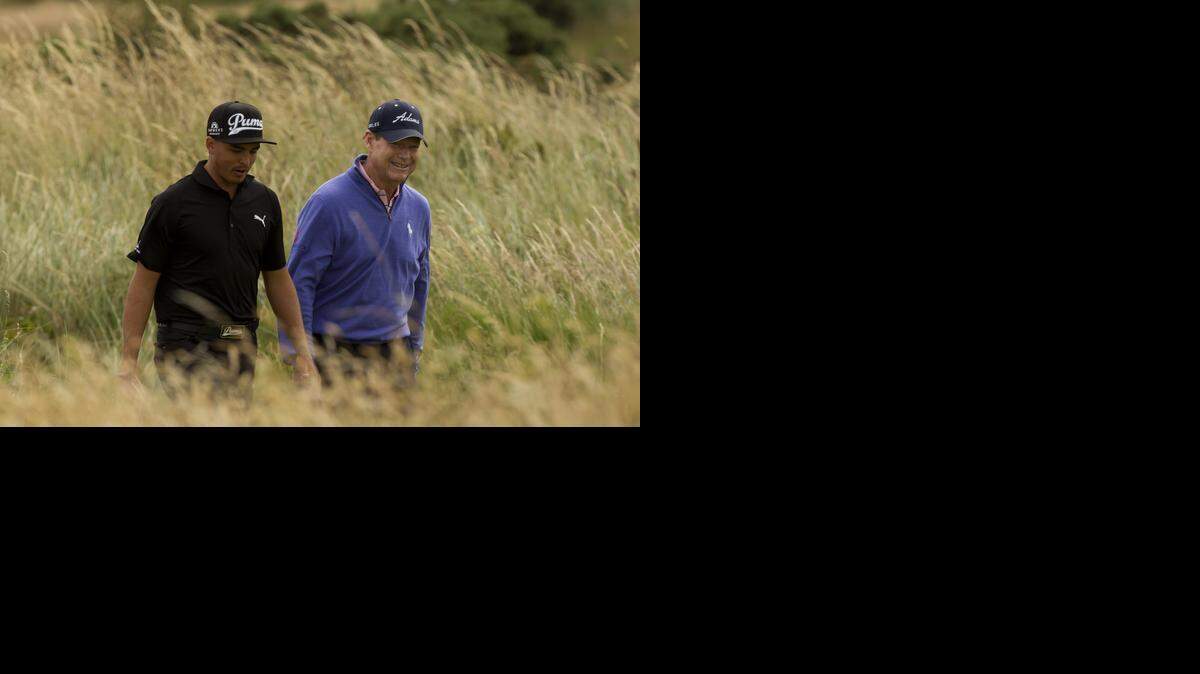 
Tom Watson, right, and Rickie Fowler, both of the US walk down the 6th fairway during a practice round at Royal Liverpool Golf Club prior to the start of the British Open Golf Championship, in Hoylake, England, Monday, July 14, 2014. The 2014 Open Championship starts on Thursday, July 17. 
