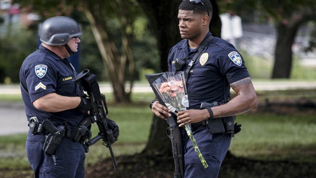 After three law enforcement officers were killed Sunday in Baton Rouge, La., a police officer carried flowers given to him while guarding Our Lady of the Lake Regional Medical Center, where officers who were injured in Sunday’s shooting were taken. The recent spate of shootings targeting law enforcement has Kansas City area officers and their families on edge.