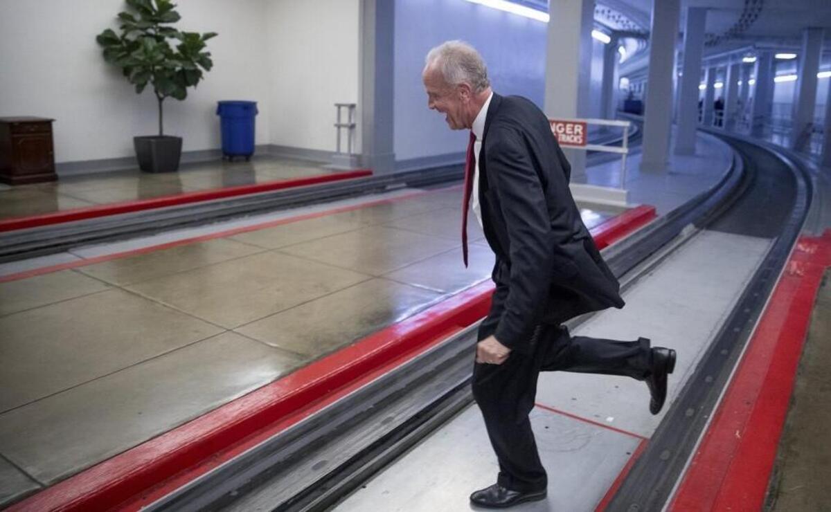 Sen. Jerry Moran, R-Kan. jumps the tracks of the Senate subway on Capitol Hill in Washington, Tuesday, July 18, 2017, to get around a large gathering of reporters as he arrives on Capitol Hill.