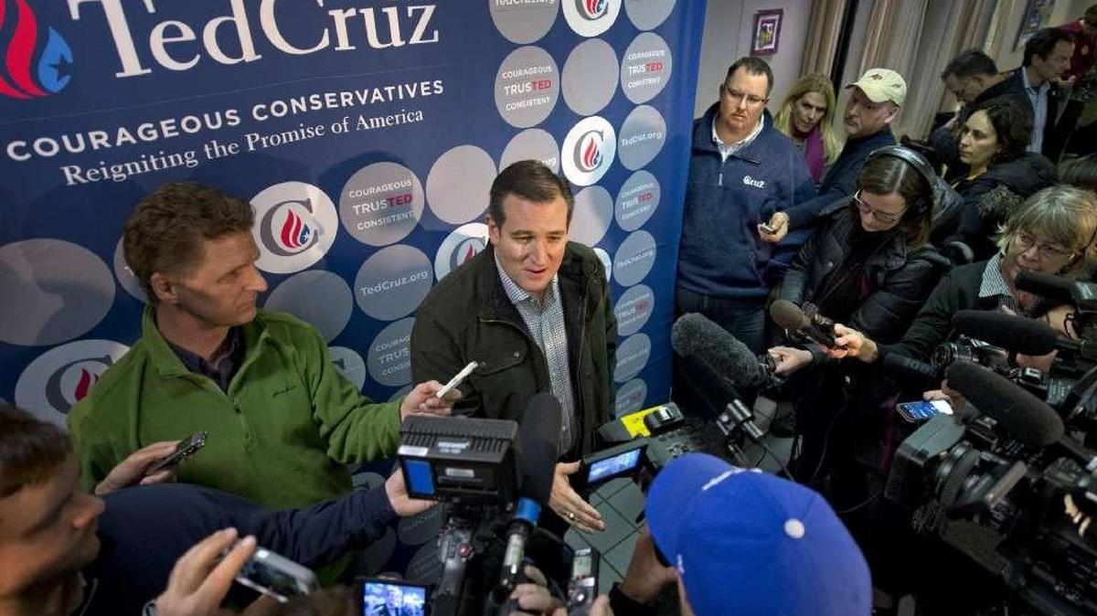 Jeff Roe (upper right wearing Cruz pullover) watched as Ted Cruz talked with the media in January 2016.