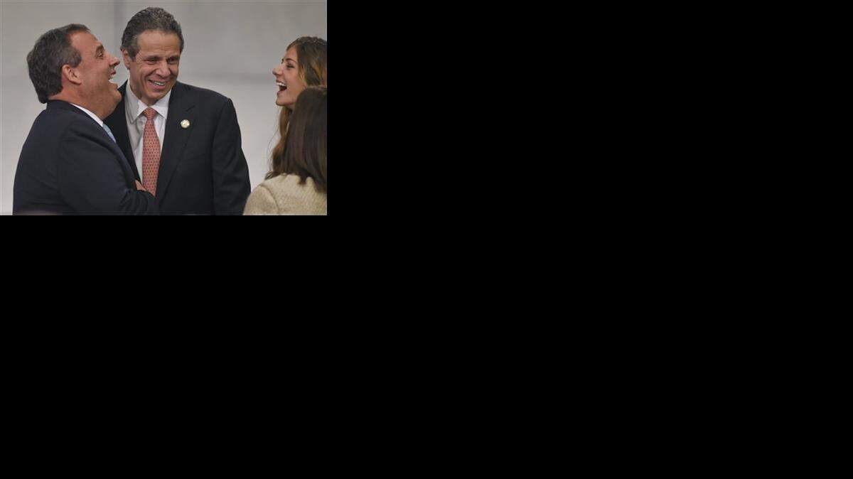 
Christie (left) at the ceremony with New York Gov. Andrew Cuomo (center)
