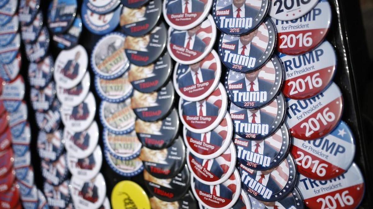 Campaign buttons are displayed for sale outside a rally for Donald Trump in Council Bluffs, Iowa.