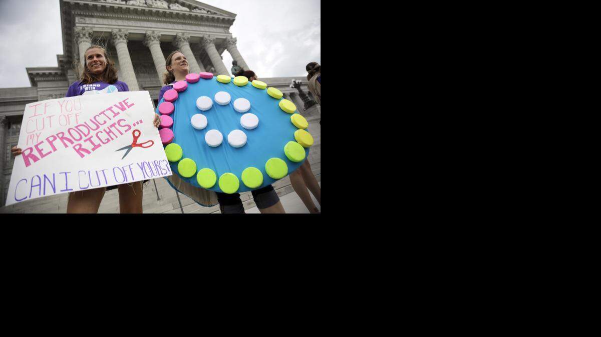 Abortion-rights supporters Dina van der Zalm (right) and Allyson Junker stood on the steps of the Missouri Capitol on Wednesday in Jefferson City as state lawmakers in a special session considered whether to override a veto by Gov. Jay Nixon of legislation requiring a 72-hour waiting period for abortions, one of the longest mandatory delays in the nation. The Missouri Senate late Wednesday turned to a rarely-used procedural move to kill a filibuster, forcing into law the waiting period.