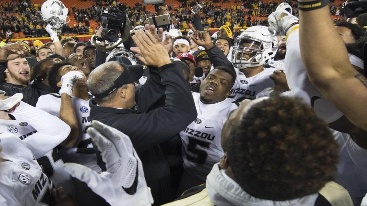 Then-coach Gary Pinkel (center) celebrated with his Missouri Tigers football team after beating BYU on Nov. 14 at Arrowhead Stadium. A week earlier, amid racial tension on campus, the team had threatened a boycott if the chancellor and university system president did not resign. Now, Missouri Reps. Rick Brattin and Kurt Bahr have proposed a bill that would cancel the scholarships of healthy student-athletes who refuse to play and fine coaches who endorse such actions.