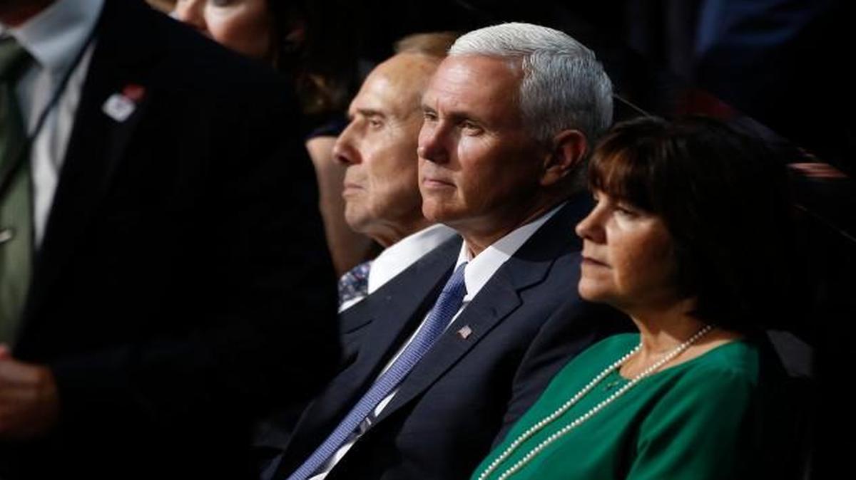 Vice presidential running mate Indiana Gov. Mike Pence sits with Sen. Bob Dole and his wife during the Republican National Convention on Monday.