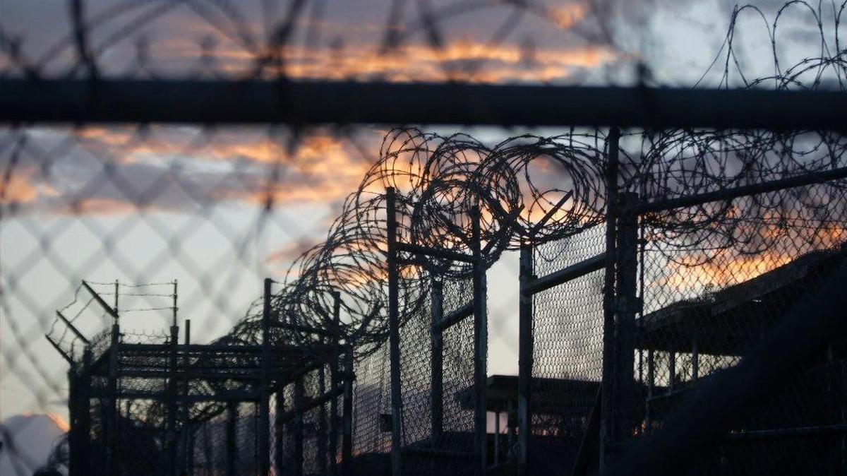 FILE - In this photo reviewed by the U.S. military, dawn arrives at the now closed Camp X-Ray, which was used as the first detention facility for al-Qaida and Taliban militants who were captured after the Sept. 11 attacks at Guantanamo Bay Naval Base, Cuba. (AP Photo/Charles Dharapak, File)