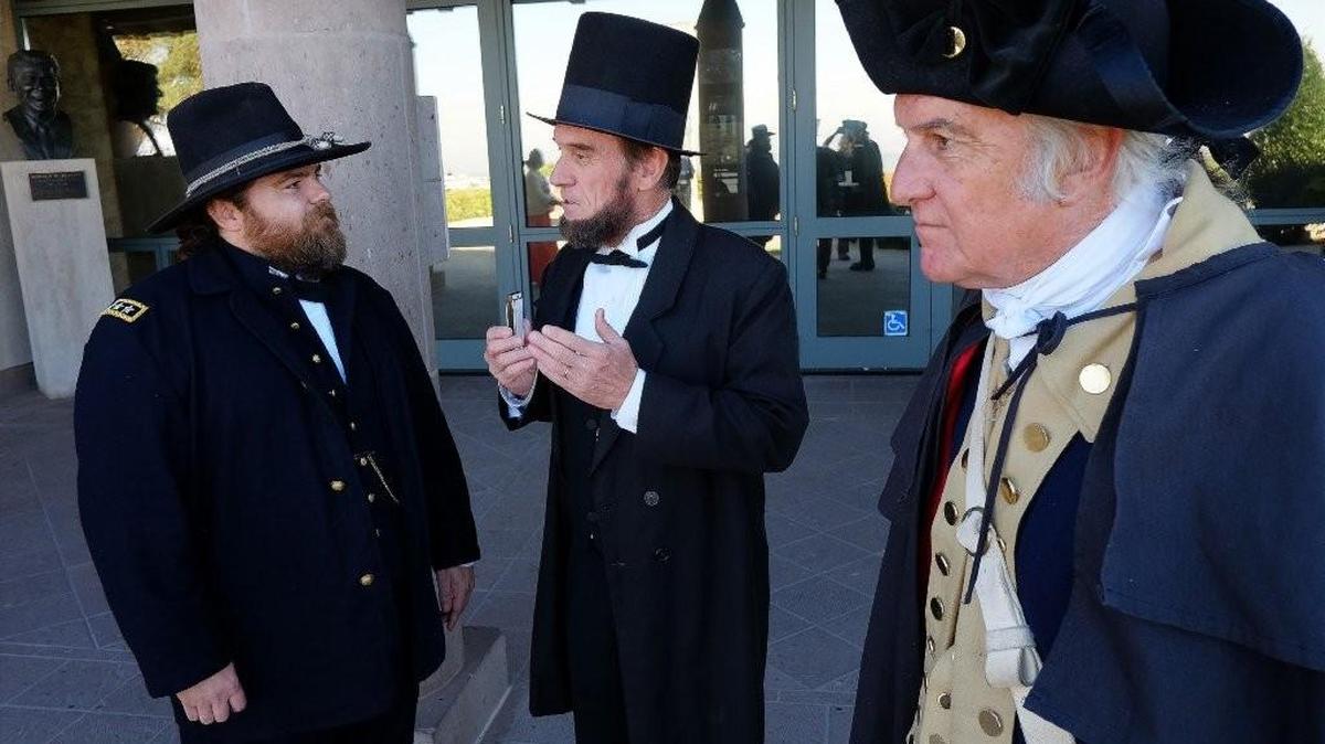 Presidential re-enactors C. Roger Cooper, portraying George Washington, right, talks with J.P. Wammack, portraying Abraham Lincoln, center, and Edward Headington, portraying Ulysses S. Grant, as they wait for visitors during the President’s Day celebration at the Ronald Reagan Presidential Library in Simi Valley, Calif. (AP Photo/Richard Vogel)