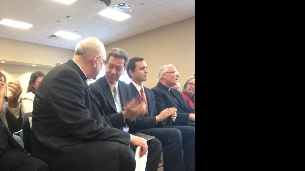 
Gov. Sam Brownback confers with Archbishop Joseph Naumann before a signing ceremony for a bill restricting abortion in the state.
