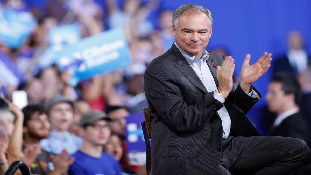Sen. Tim Kaine, Virginia Democrat, listens as Democratic presidential candidate Hillary Clinton speaks during a campaign rally at Florida International University Panther Arena in Miami, Saturday.
