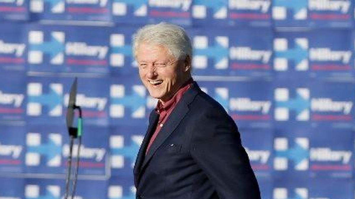 Former president Bill Clinton walks on stage before speaking during a rally for his wife in Iowa (AP Photo/Charlie Neibergall)