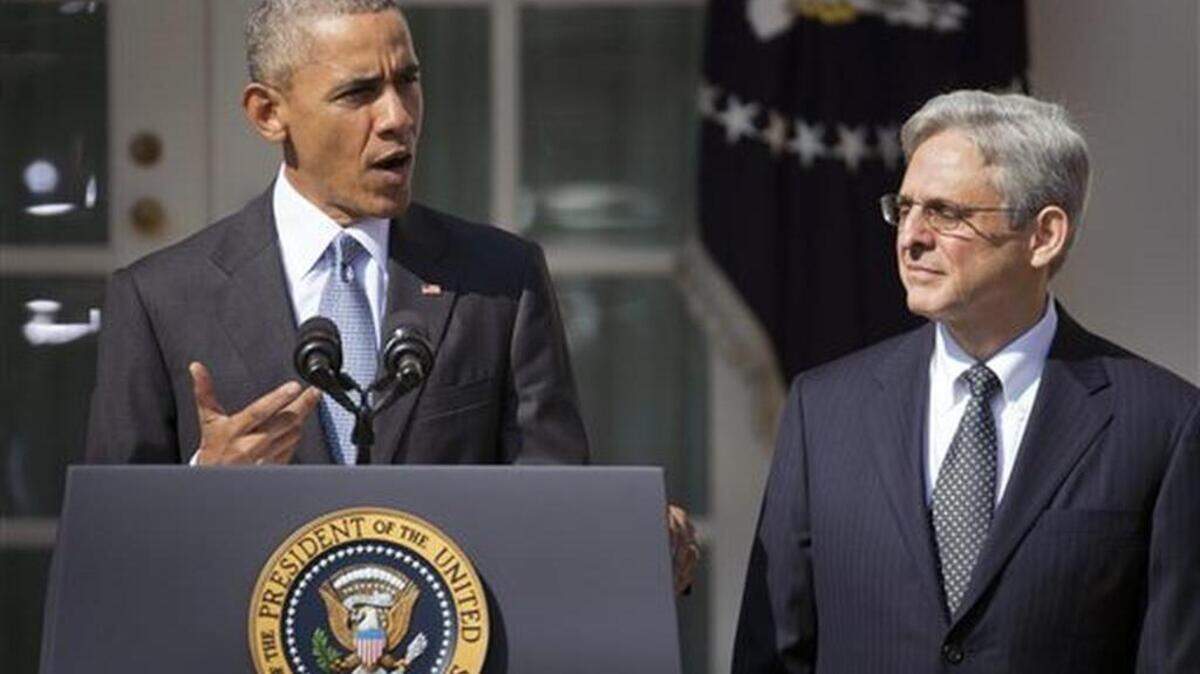 Federal appeals court judge Merrick Garland, right, stands with President Barack Obama as he is introduced as Obama's nominee for the Supreme Court during an announcement in the Rose Garden of the White House, in Washington, Wednesday, March 16, 2016.