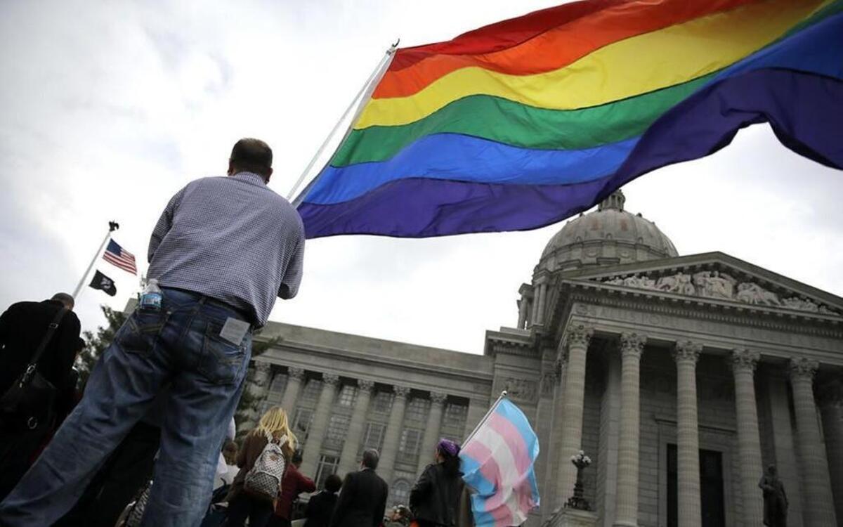 Gay-rights supporter Mathew “Skippy” Mauldin held a flag during a rally outside the Missouri Capitol in March as the legislature debated a “religious freedoms” bill. The measure ultimately died in committee, but members of the LGBT community in Missouri are still not protected from discrimination.