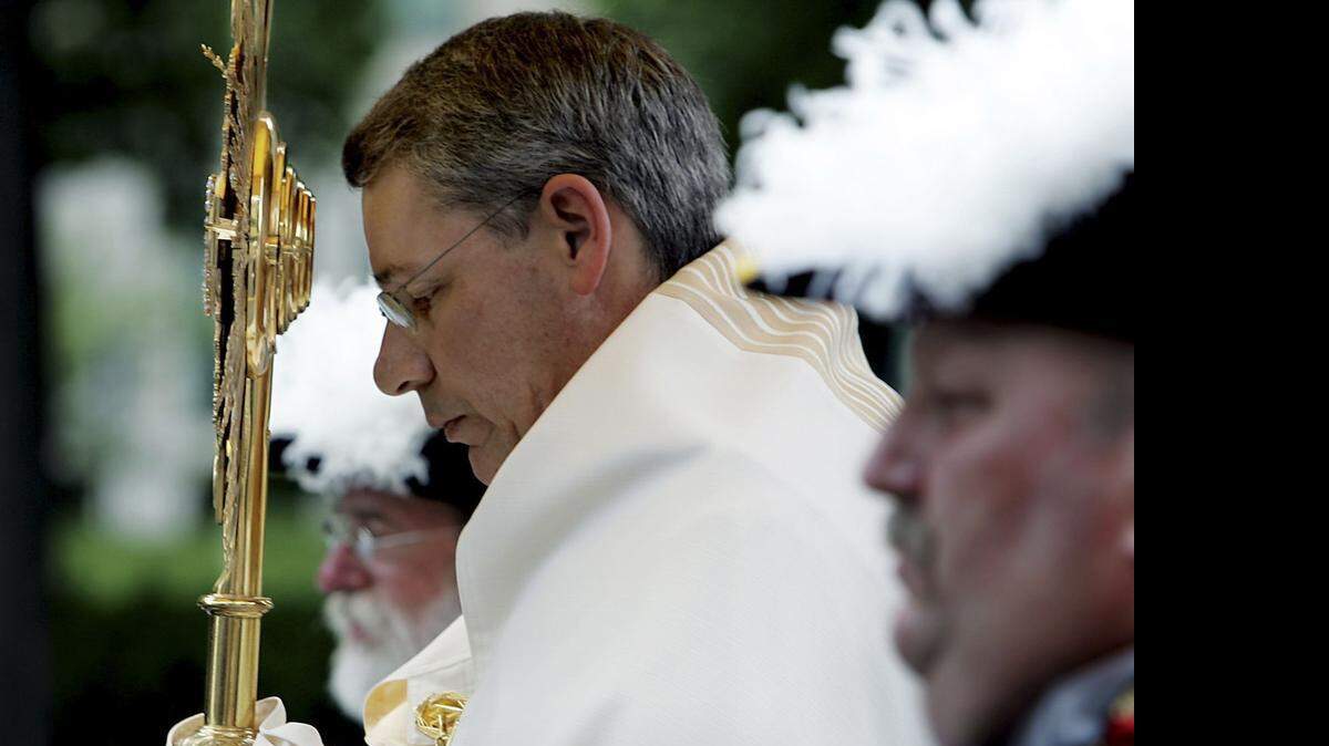 
Bishop Robert W. Finn leads a procession down Broadway in 2005 to celebrate the Feast of Corpus Christi
