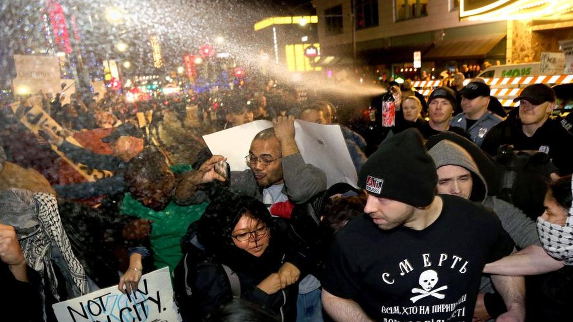 Police pepper spray a crowd of protesters and journalists outside the Arvest Bank Theater at The Midland on Saturday, March 12, 2016, during a rally for Donald Trump in Kansas City, Mo.
