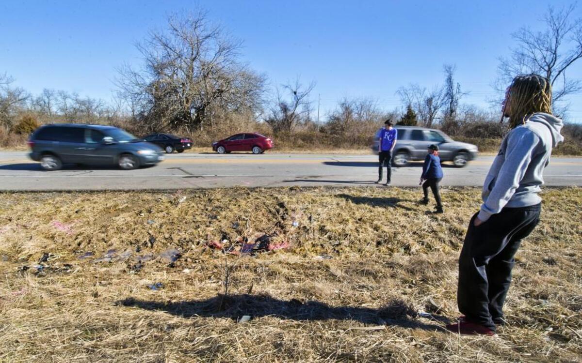 Friends of the victims of a fatal accident that happened Monday afternoon on Southwest Pryor Road about half a mile south of Longview Road in Lee’s Summit gathered Tuesday at the scene to pay their respects. Pictured are D.J. Robinson Jr. (right), Amanda Purvey and Adam Williams (left).