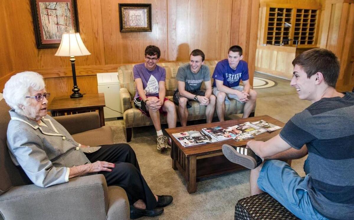 
FarmHouse Fraternity housemother Maybelle Mertz talked with Andy Llewelyn (from left), 20, Colin Hitz, 21, Olathe native T.J. Crow, 22, and Levi Bailey, 20, on the Kansas State University campus in Manhattan. 
