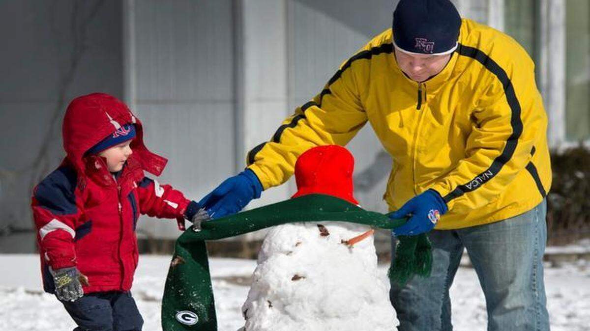
Turner Robertson, 4, helped his dad, Ryan Robertson, dress up a snowman they built with help of sister, Ari, and mom, Angela, on Sunday morning in the front yard of their Kansas City, North, home.
