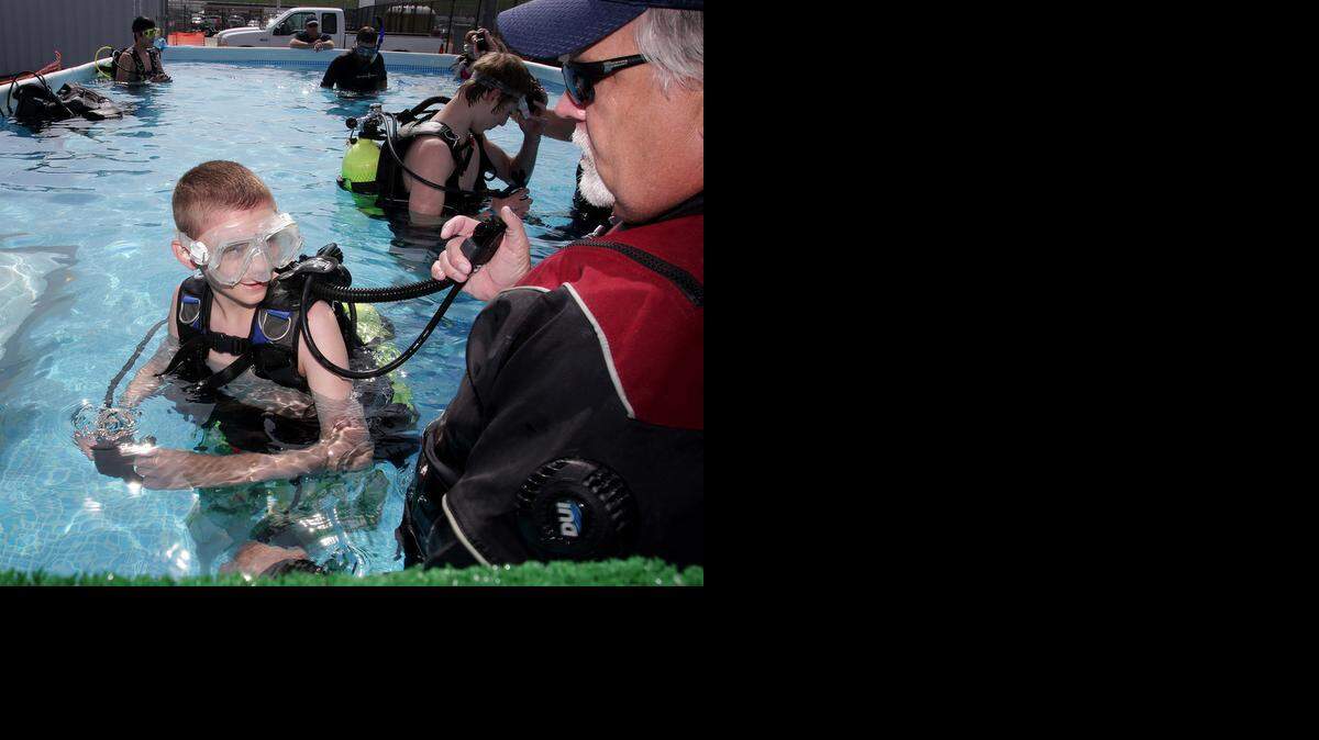 
In a portable pool Saturday at Kansas Speedway, Alex Stoneburner, 14, of Troop 221 in Independence, got a chance to experience scuba diving at Scouting 500. Bill Feller of Playground Dive Shop in Blue Springs gave the instructions.
