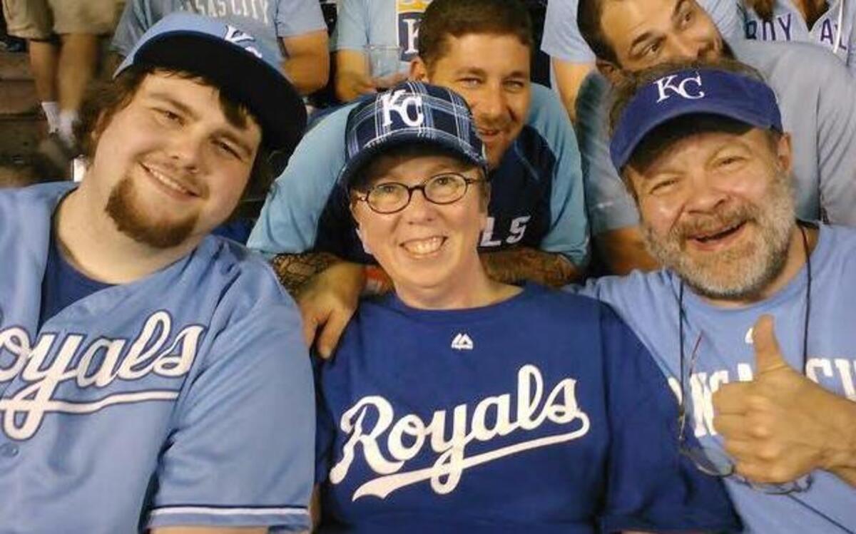 
The Mengel Family - Emmanuel, Tammy and Dana - at Kauffman Stadium for Tuesday’s Wild Card Game. The family came in search of therapy after the death two days before of 16-year-old daughter Gloria.
