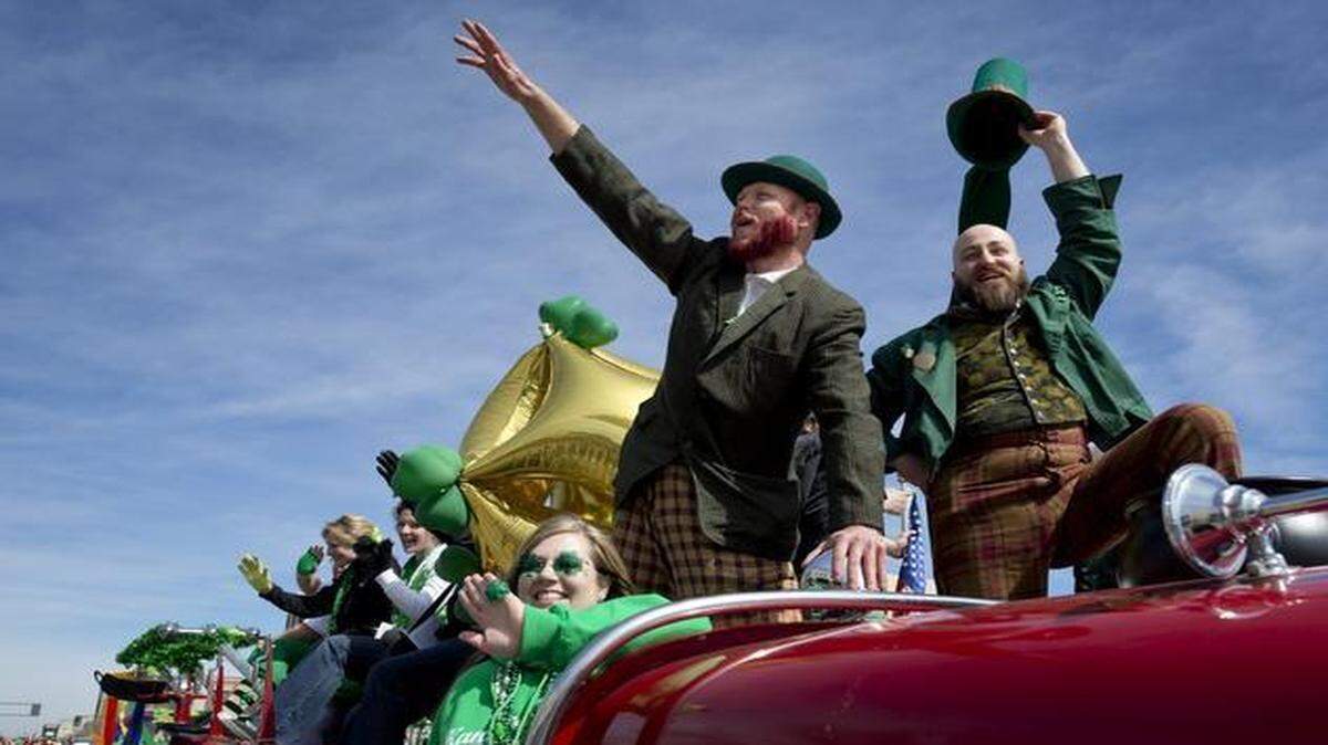 
At last year’s Kansas City St. Patrick’s Day Parade, Jesper Nielsen (top left) and Clay Jarratt waved to the crowd from the top of a fire engine. As it has since 2009, the 2015 parade will proceed south on Broadway.
