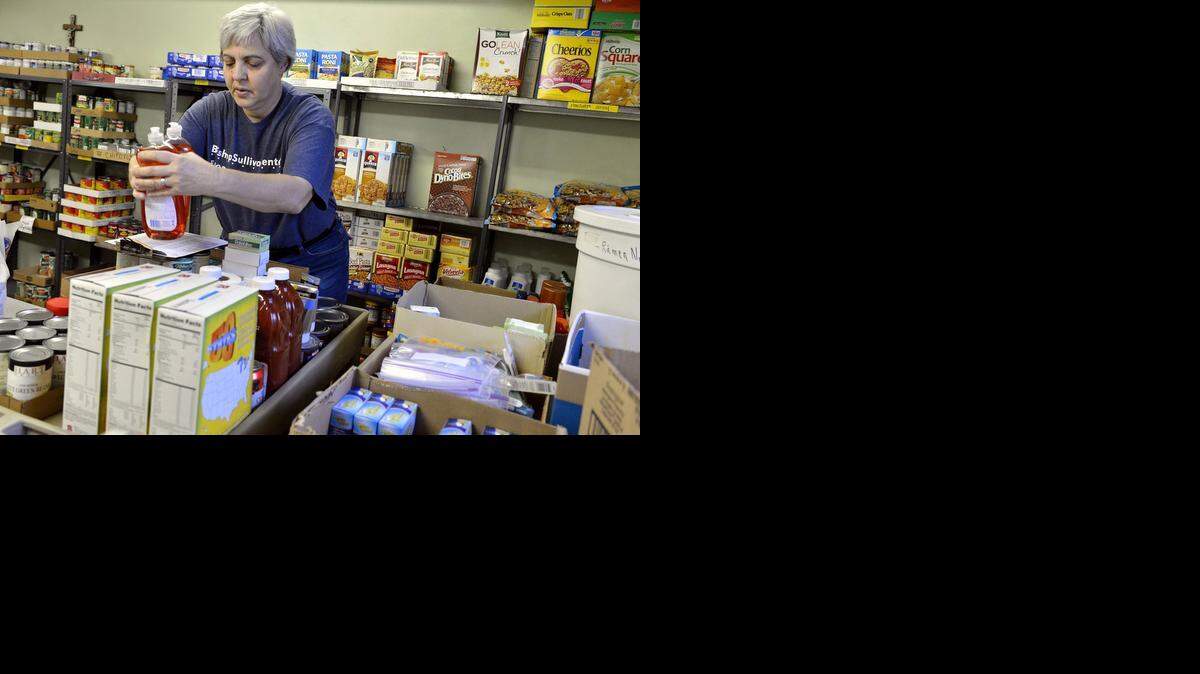 
Colleen Simon filled an order in the food pantry of St. Francis Xavier Church earlier this year.
