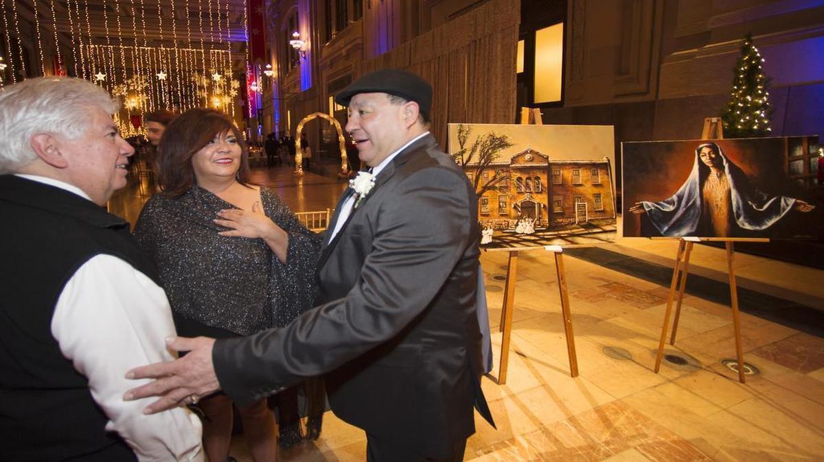 Joe Frank Chato Garcia (left) of Omaha, Neb., and Diana De Latorre and Robert Tinoco of Kansas City exchanged greetings as Saturday’s celebration began.