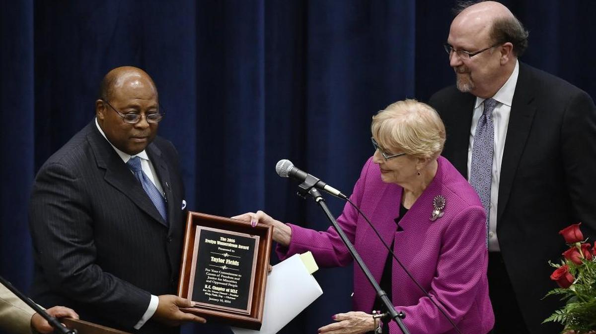 In this file photo, attorney Taylor Fields, left, receives the Evelyn Wasserstrom Award from Judy Hellman and the Rev. Robert Lee Hill in 2016. Fields died late Wednesday at age 77.