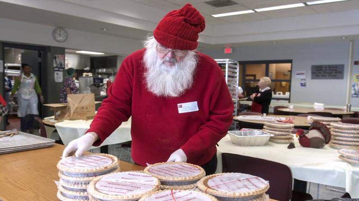 
Salvation Army volunteer Victor Ellison — not to be confused with Santa — prepared to cut pies that would be delivered to the elderly and others later on Thursday in Kansas City. More than 900 homebound people received the Salvation Army’s Thanksgiving dinners. 
