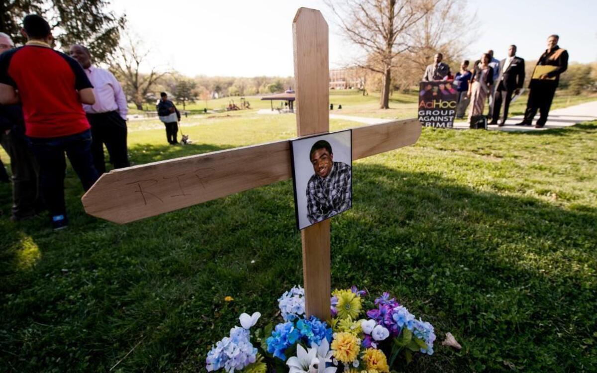 Neighbors, friends and family members gathered Wednesday around the memorial for 18-year-old Asaan Williams during a dedication event for the installation of surveillance cameras at Seven Oaks Park, 3700 Kensington Ave. in Kansas City. Williams was shot and killed just over a year ago. The killer is still at large.