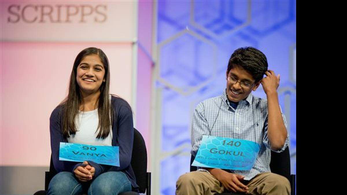 Vanya Shivashankar, 13, left, of Olathe, Kan., and Gokul Venkatachalam, 14, right, of St. Louis, sit on stage during the finals of the Scripps National Spelling Bee on Thursday in Oxon Hill, Md.  The Spelling Bee ended in tie for 2nd year; Vanya Shivashankar, Gokul Venkatachalam co-champions. (May 28, 2015)