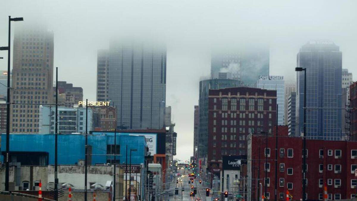 Clouds obscured the downtown Kansas City skyline Friday morning, with snow possible later in the day as the temperatures drop below freezing.