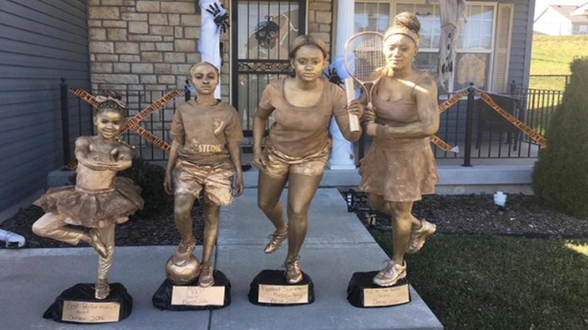 This photo of Kansas City mom Denise Hill, far right, and her daughters dressed up as golden trophies for Halloween has gone viral.