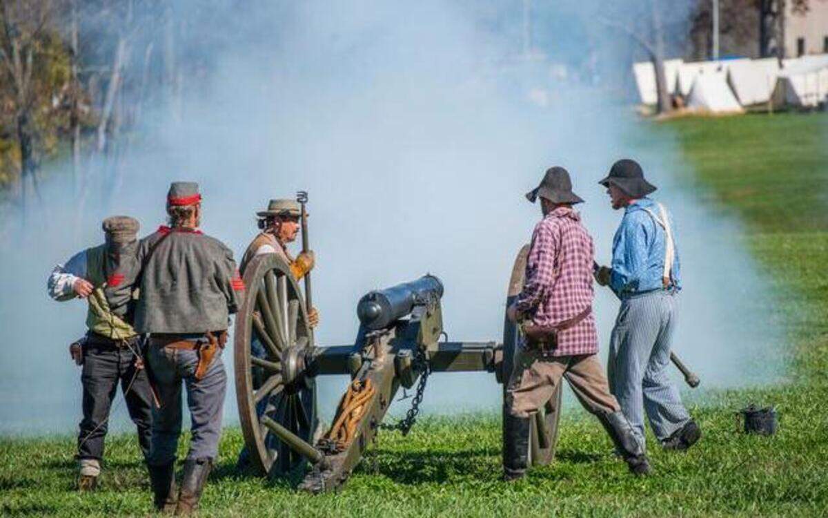 
A Confederate battery prepared to reload and fire another volley at Union troops during Sunday’s Battle of Westport re-enactment. The actors pay for much of their own equipment and travel.
