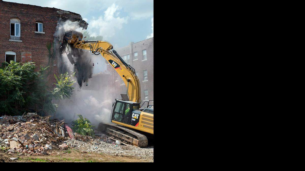 
Workers have begun final demolition of the three-story brick church at Independence and Benton boulevards that suffered a collapsed wall on Aug. 7. A track hoe ripped away at the east side of the structure on Thursday afternoon, Aug. 28, 2014. 
