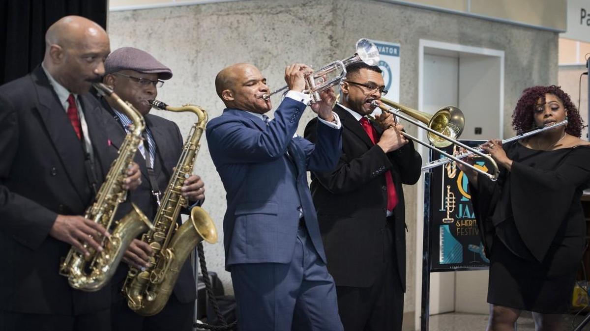 Ronnie McFadden (far left) plays a saxophone during a 2017 performance at Kansas City International Airport.