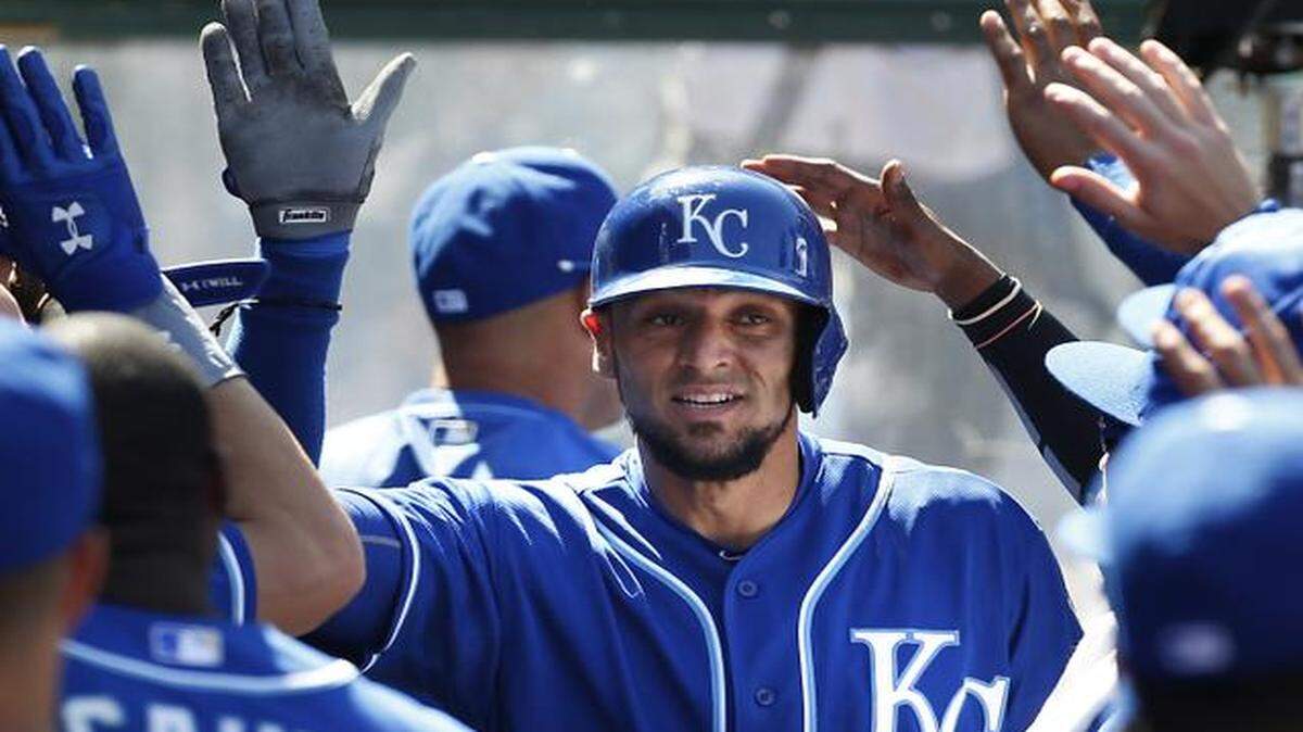 
Kansas City Royals' Paulo Orlando is congratulated in the dugout after scoring on a double by Omar Infante in the seventh inning against the Los Angeles Angels in a baseball game in Anaheim, Calif. Sunday, April 12, 2015. The Royals won 9-2. 
