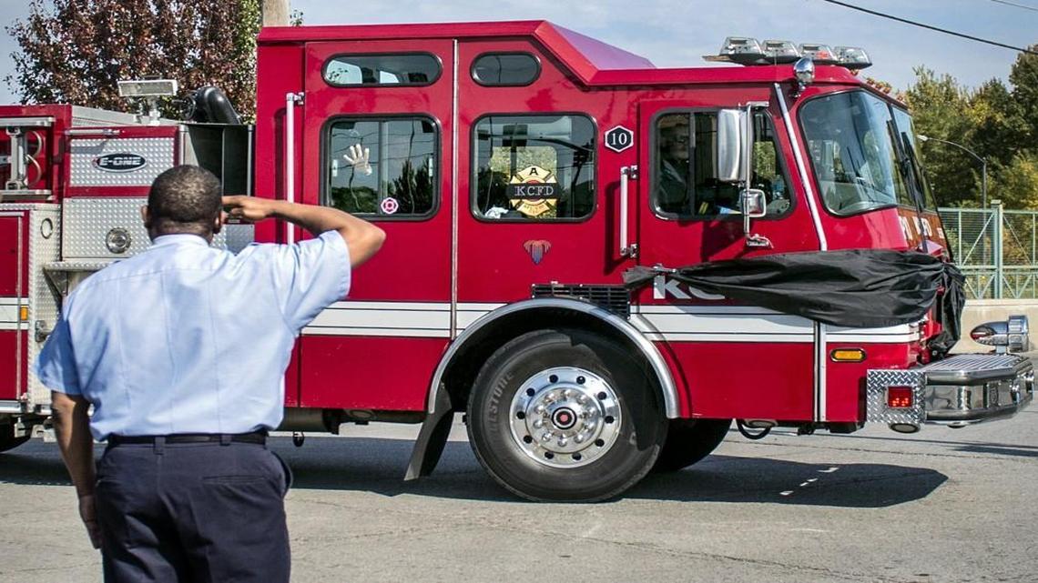 Capt. Darryl Wells of the Kansas City Fire Department saluted as a fire truck passed Wednesday on Bruce R. Watkins Drive and 63rd Street during the funeral procession for firefighter John Mesh.