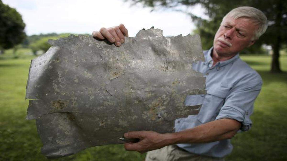 Ric Gillespie, executive director of The International Group for Historic Aircraft Recovery, holds a scrap of airplane wreckage that he contends is consistent with a window patch on the Lockheed Electra that Amelia Earhart was flying when she disappeared in 1937.