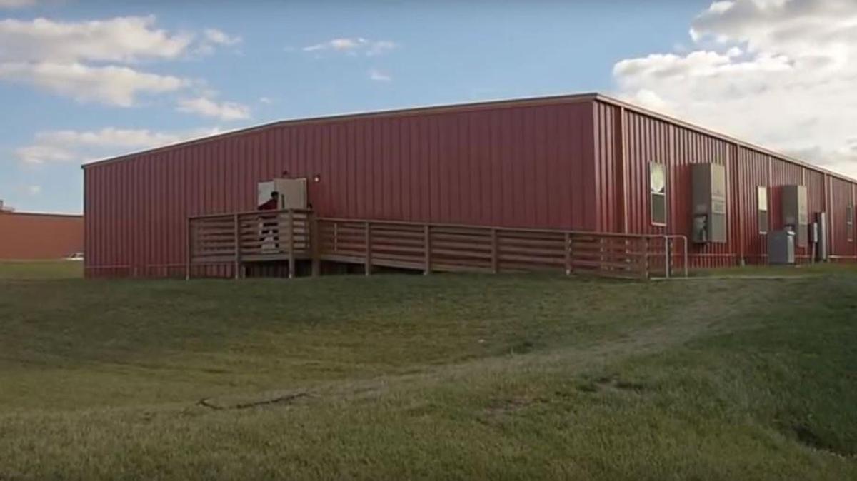 A student leaves the Piper School District’s eight-classroom modular “mobile” unit, built a few years ago to provide 240 extra seats in an overcrowded district. On Thursday, Piper voters approved a $35 million bond issue to build a new school in the ballooning district.