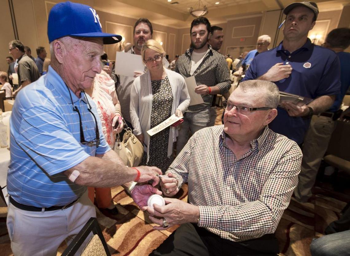 Former Kansas City Royals grounds keeper George Toma (left) got a baseball signed by Don Denkinger (right), who made the infamous call in game six of the 1985 World Series that allowed the Royals to win, during the 1985 Kansas City Royals reunion at Harrah’s Casino on Thursday, August 20, 2015, in North Kansas City, Missouri.