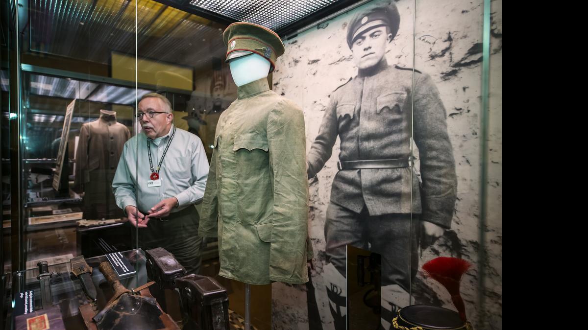 
Doran Cart, curator at the National World War I Museum at Liberty Memorial, on Thursday showed off a Bulgarian infantry uniform (center), one of many items on display in the exhibit “Sand to Snow: Global War 1915” The exhibit opens Friday at the museum.

