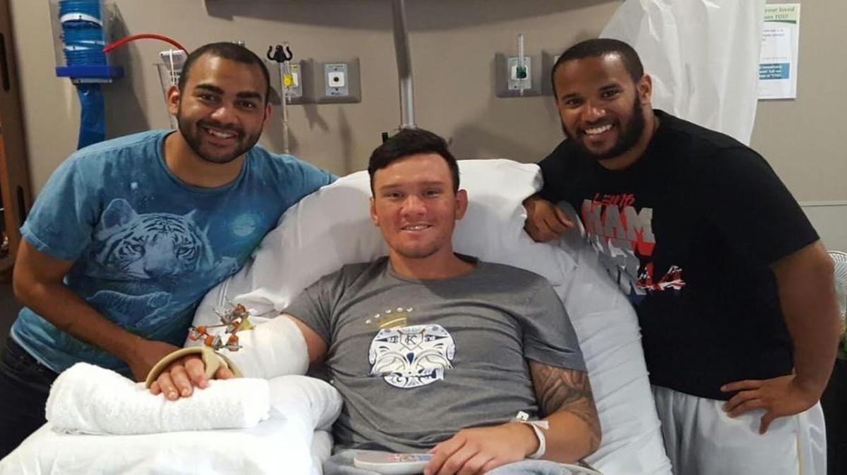 Colin McNair, left, and Nathan Johnson, right, visit Andrew Carillo in the hospital Wednesday after he fell into a window and was severely injured. McNair and Johnson happened to be nearby to help Sunday when Carillo was hurt.